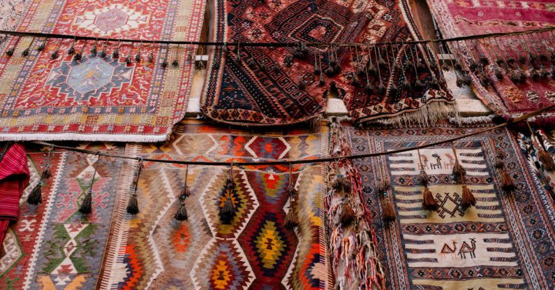Middle East Market - Colorful handmade weaved with oriental ornament middle east rugs hanging in open market