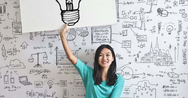 REIT Graph - Woman Draw a Light bulb in White Board