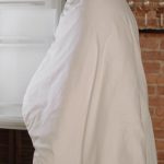 Housing Shortage - Woman in White Hijab Standing Near White Top Mount Refrigerator