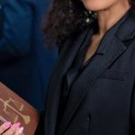 Law Book - A Woman in Black Blazer Holding a Law Book